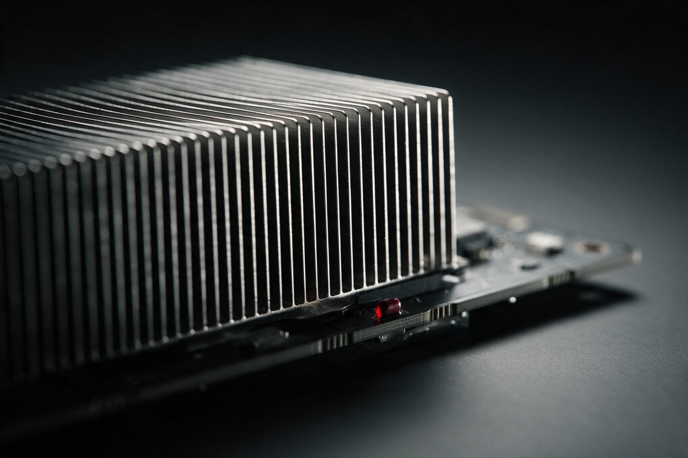 Macro view of a GPU accelerator heatsink fin stack in raking light