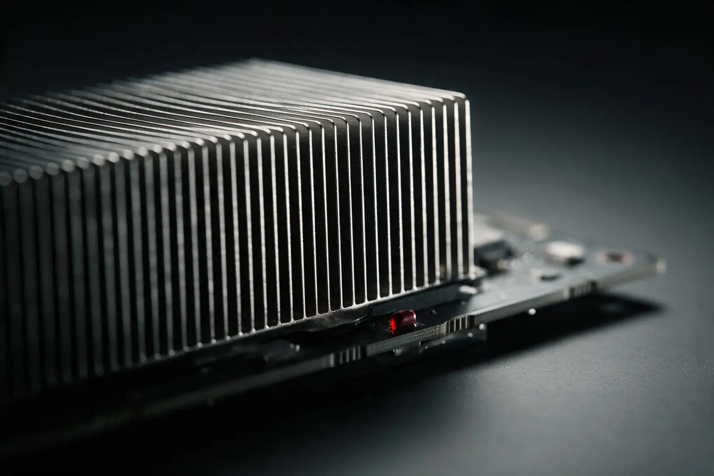 Macro view of a GPU accelerator heatsink fin stack in raking light