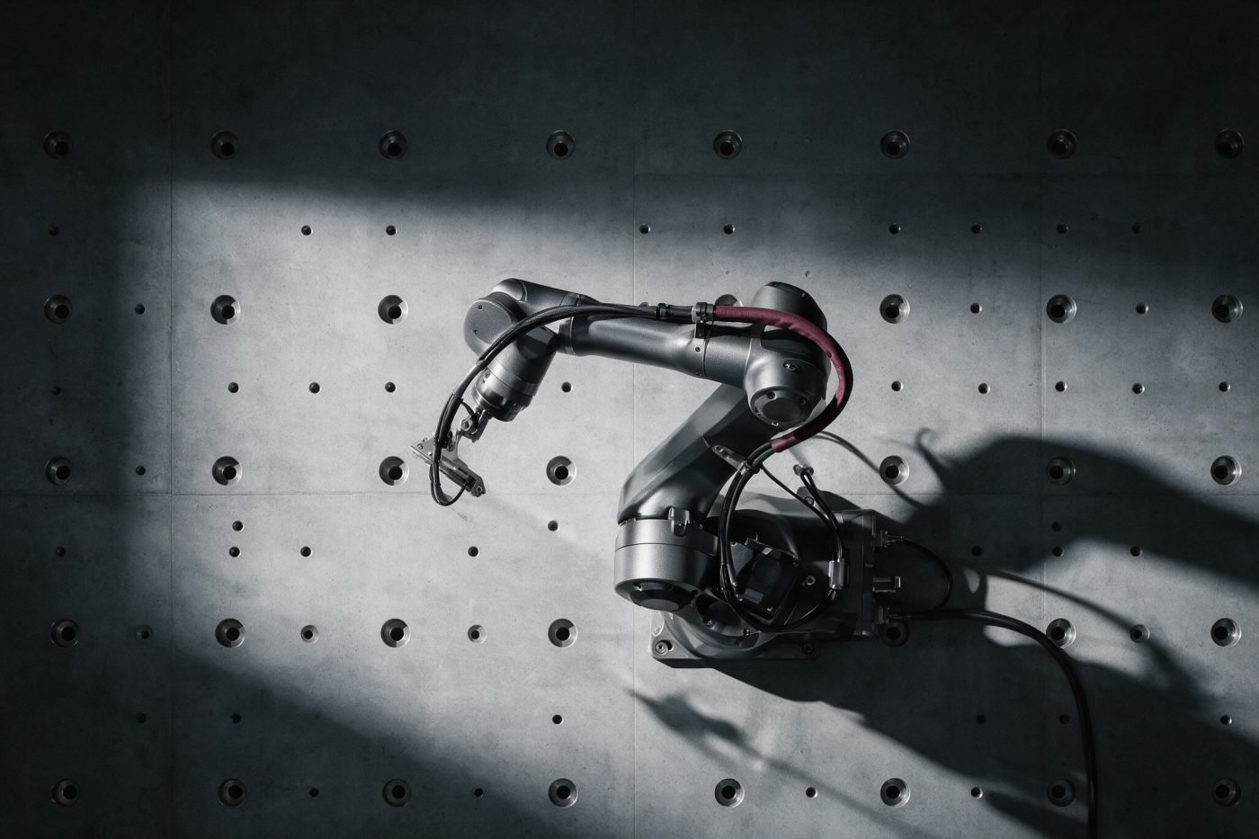 Precision industrial robotic arm at rest on a machined concrete surface